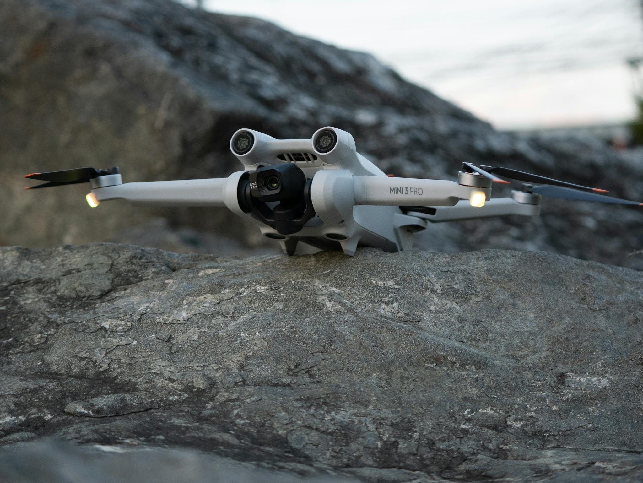 Sleek and advanced camera drone poised on a rugged rock surface, ready for action.